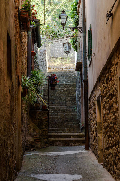 Charming little tight narrow street with stairs in Volterra town in Tuscany, Italy, Europe