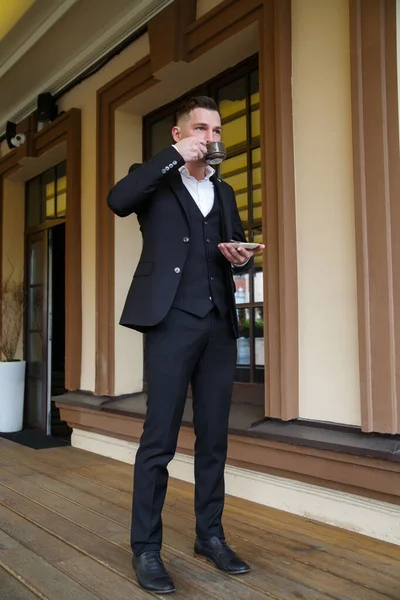 양복을 매력적 남자가 커피를 테라스 있습니다 — 스톡 사진