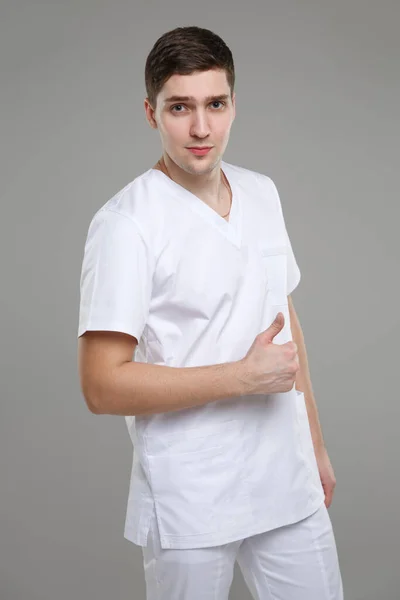 Young Man Medical Overalls Shows Raised Thumb One Arm Isolated — Stock Photo, Image