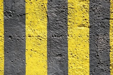 Texture wallpaper, painted in yellow and black stripes untreated concrete surface.