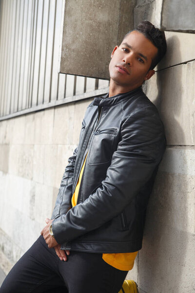 Portrait of a young attractive latinos man on an urban city street.
