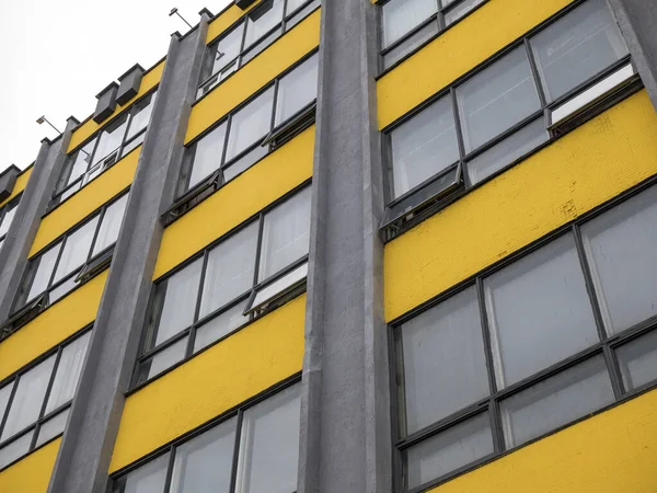 Geometric facade of building in the colors 2021. Yellow and gray wall. Year color concept