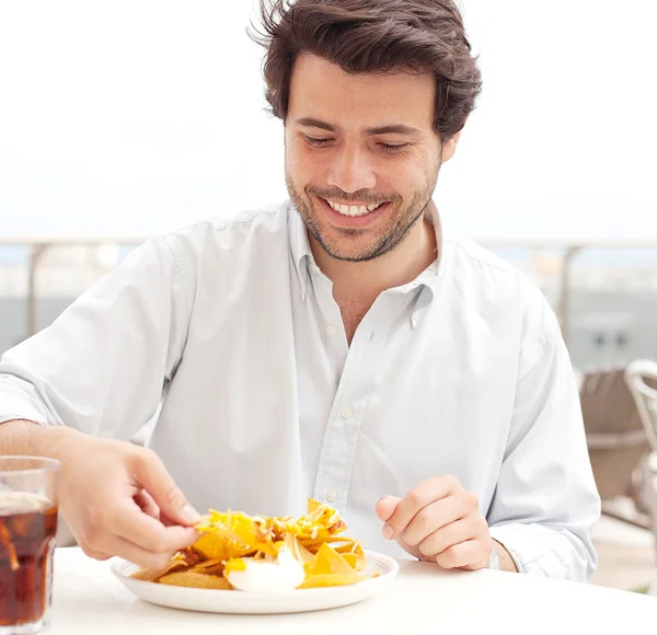 Young man eating chips