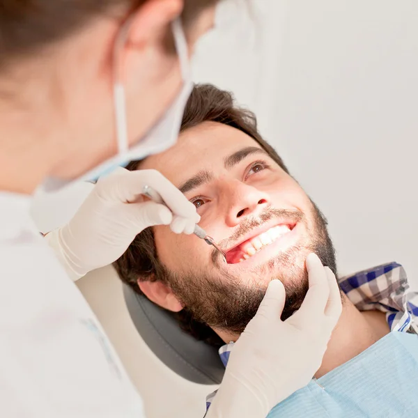 Jonge gelukkig man en vrouw in een tandheelkundige onderzoek op tandarts — Stockfoto