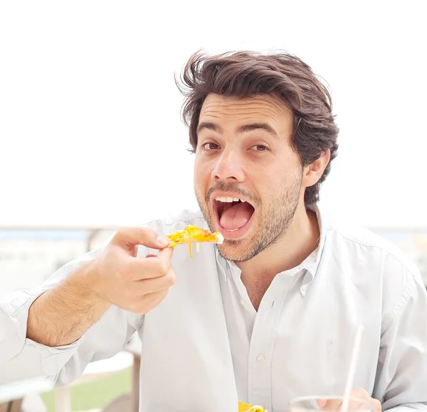 Young man eating nachos Stock Picture