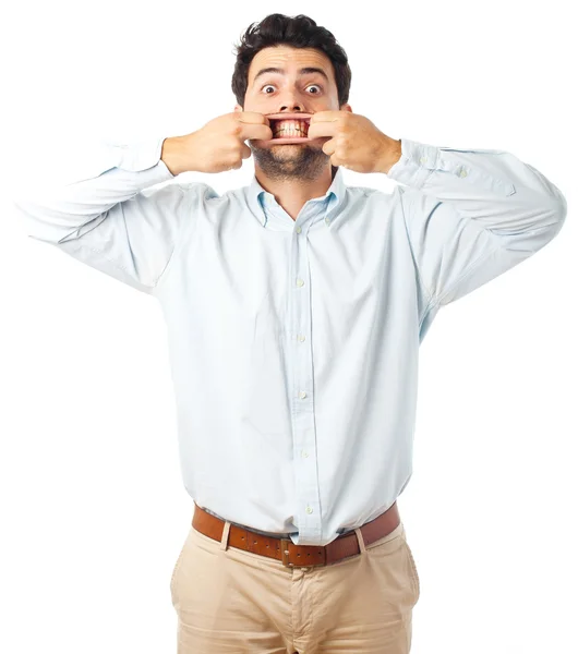 Young man opening mouth with hands on a white background — ストック写真