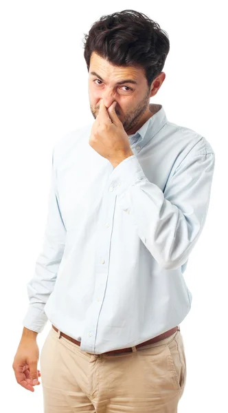 Hombre con gesto apestoso sobre un fondo blanco — Foto de Stock