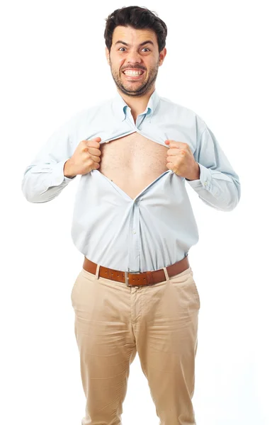 Jovem agindo como um super-herói e rasgando sua camisa em um fundo branco — Fotografia de Stock