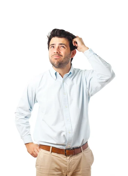 Giovane uomo graffiare la testa su uno sfondo bianco — Foto Stock