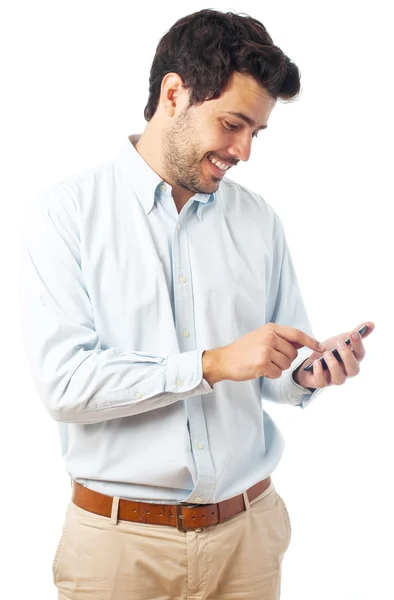 Young man with an smartphone on a white background — Zdjęcie stockowe