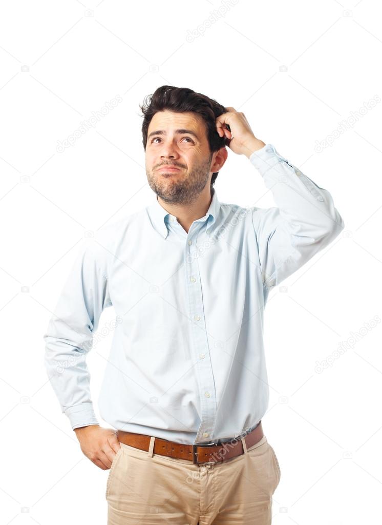 young man scratching head on a white background