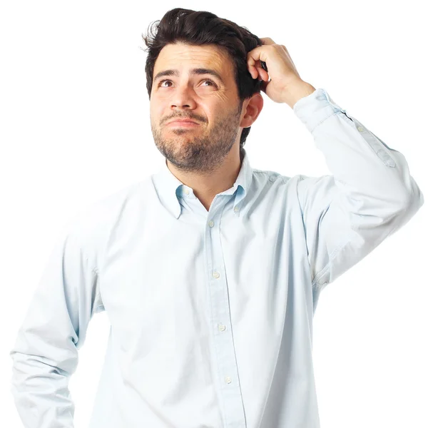 young man scratching head on a white background