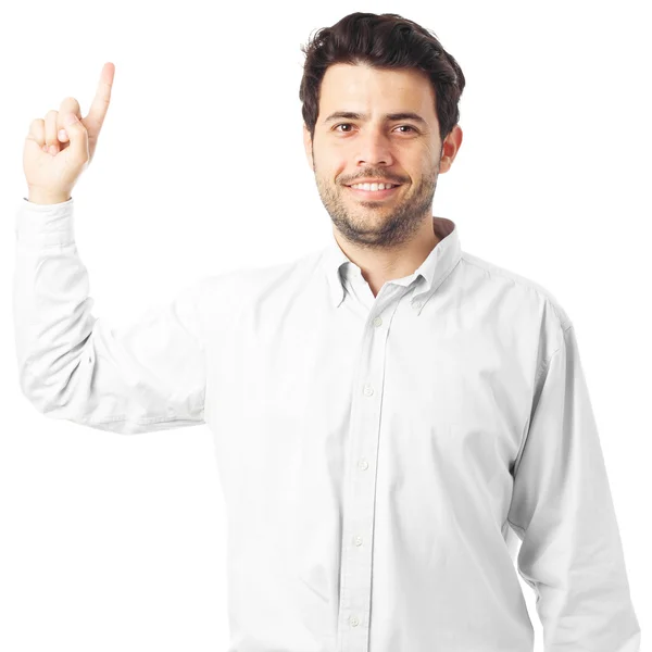 Young man pointing up on a white background — Stockfoto