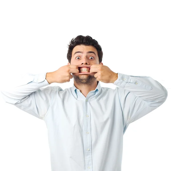 Young man opening mouth with hands on a white background — ストック写真