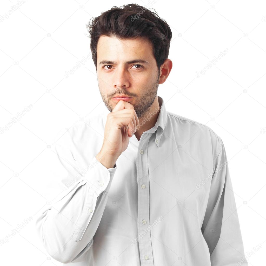 young man thinking with a hand on chin on a white background
