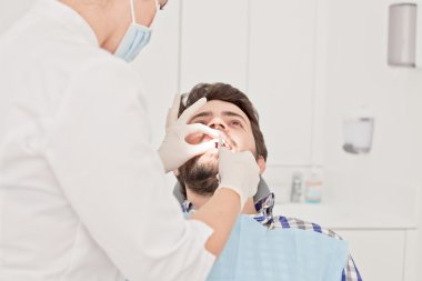 Genç mutlu erkek ve kadın diş hekimi, diş sınavında