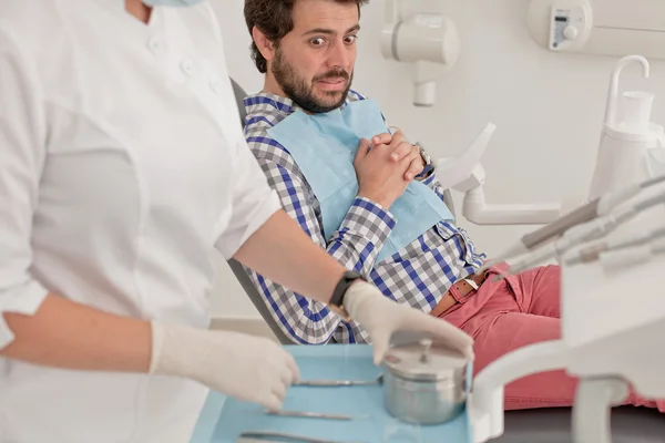 Young man and woman in a dental examination at dentist — Stock Photo, Image