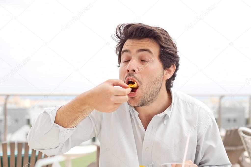 Young man eating chips