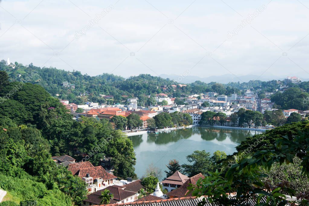 Aerial view of Kandy, a beautiful city at Sri Lanka with buildings, a square lake and many trees. 