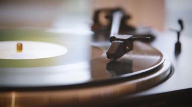 Zaman ayarlı. İğne vinil plaktan yükseliyor. Vinil plak kaydı durdu. Vinil plak dönüyor. İğne vinil plakla çalınıyor. Eski pikap. Eski