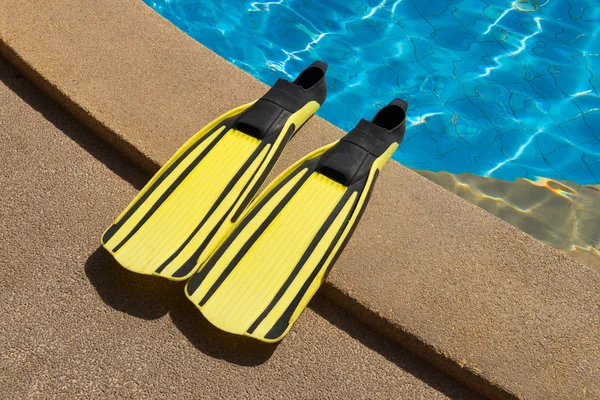 Two flippers for diving on poolside — Stock Photo, Image