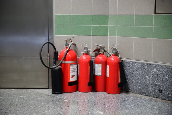 Fire extinguishers in room corner — Stock Photo, Image