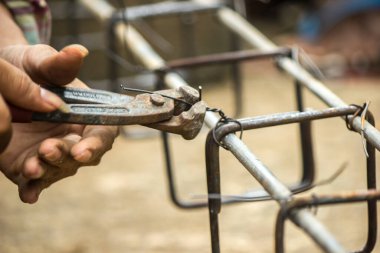 Tamirci çelikle bağlanmış bir tel kullanıyor..