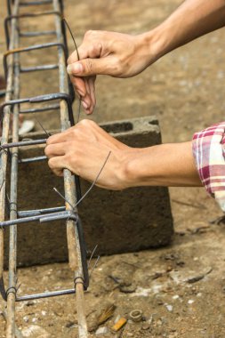 Tamirci çelikle bağlanmış bir tel kullanıyor..
