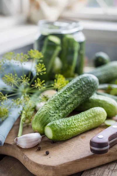 Pickles .Pouring brine into cucumbers .  Gucumbers , garlic ,dill, currant leaves in a glass jar. Russian Traditional food .  Pickled cucumbers . Recipes .