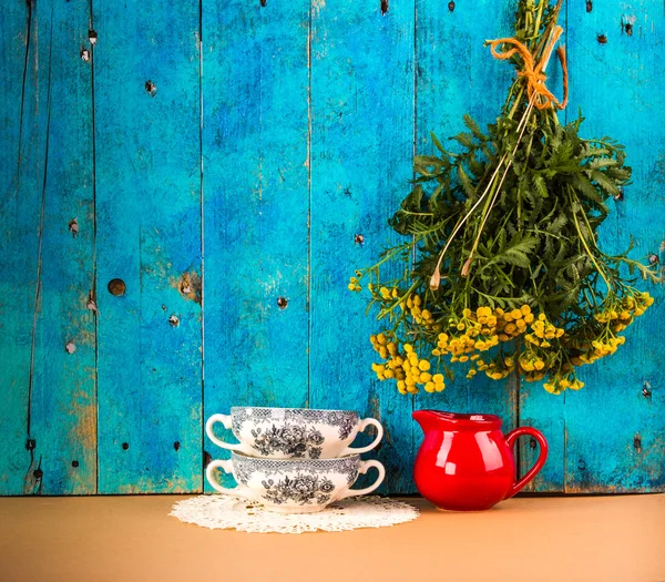 Rustic still life with on a blue background with simple branch of camomile — Stock Photo, Image