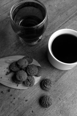 Photo of dry chocolate cake and a cup of coffee on a wooden table