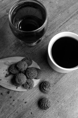 Photo of dry chocolate cake and a cup of coffee on a wooden table