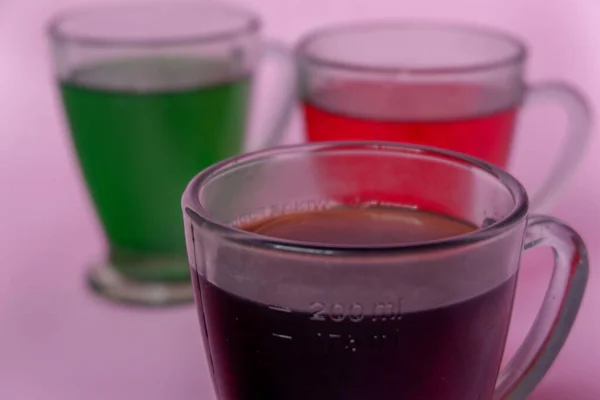 Photo of colorful drinks on pink background