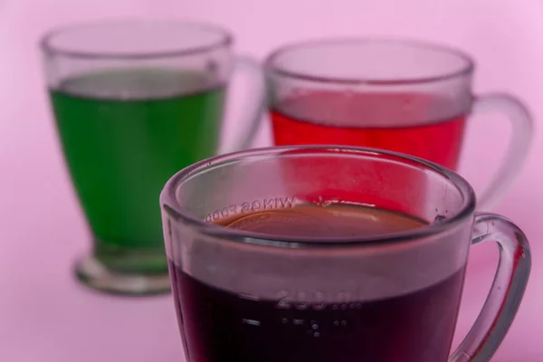 Photo of colorful drinks on pink background