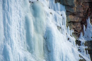 icicles on the rocks in the snow, winter waterfall clipart