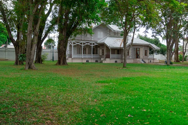 Yeşil çimlerle çevrili tarihi bir ev.