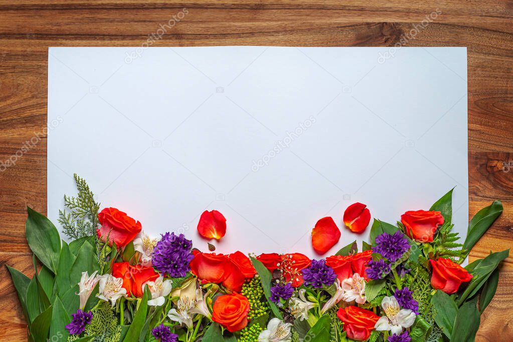 Red roses, white Alstroemeria, Gypsophila elegans in bouquets. White, wooden background. Festive decoration