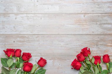 Red roses in bouquets on bottom of wooden wall. Layout for postcards, invitations for Valentine's Day 14 february, Engagement, wedding anniversary, Birthday  preparation.