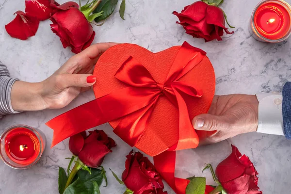 Female Male Hands Gives Gift Red Heart Shaped Box Satin — Φωτογραφία Αρχείου