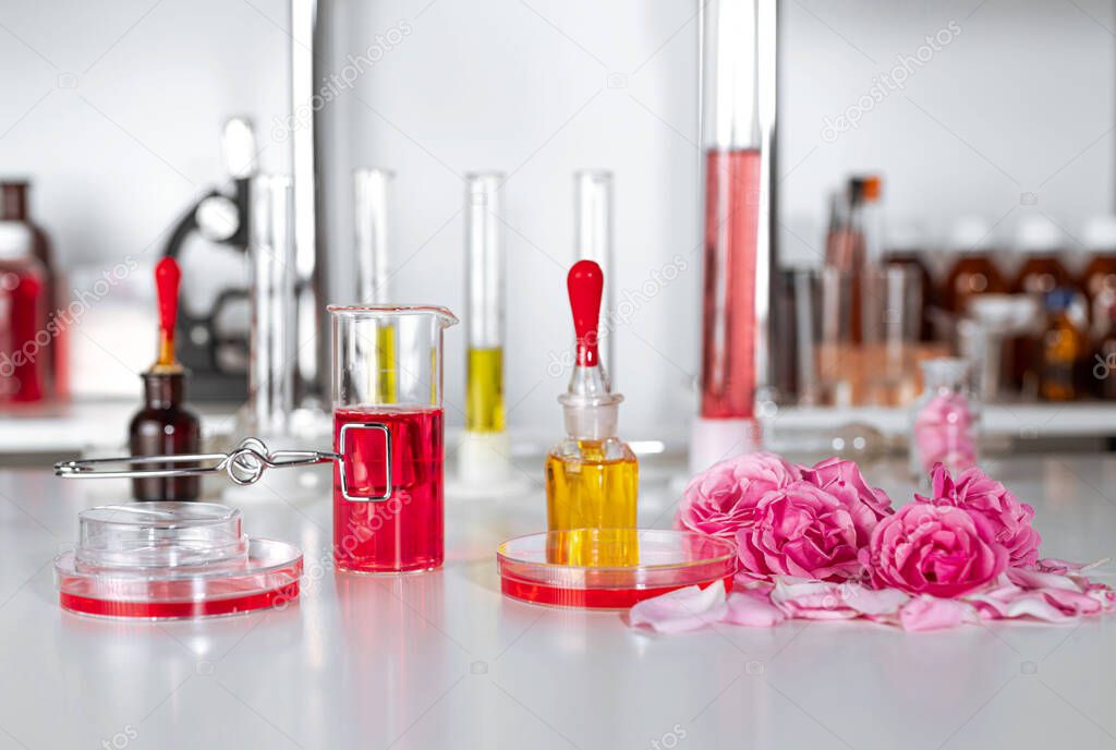 Parfum's laboratory equipment, supplies, jars, bottles, cylinders, beakers, graduate, test-mixer, medicine-glass, rose oil, buds.