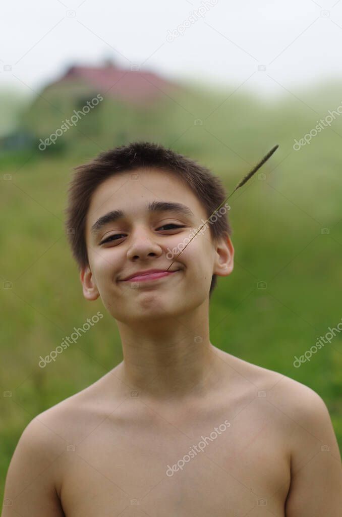 Boy lifestyle portrait. Childhood mood. Farmer, hay, vacation