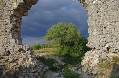 Kırım 'ın güneybatısında Trebizond Kırım İmparatorluğu' ndaki Theodoro-Mangup Prensliği 'nin kalıntıları. Şehir simgeleriyle dolu dağ manzarası. Kırık taş duvar dokuları