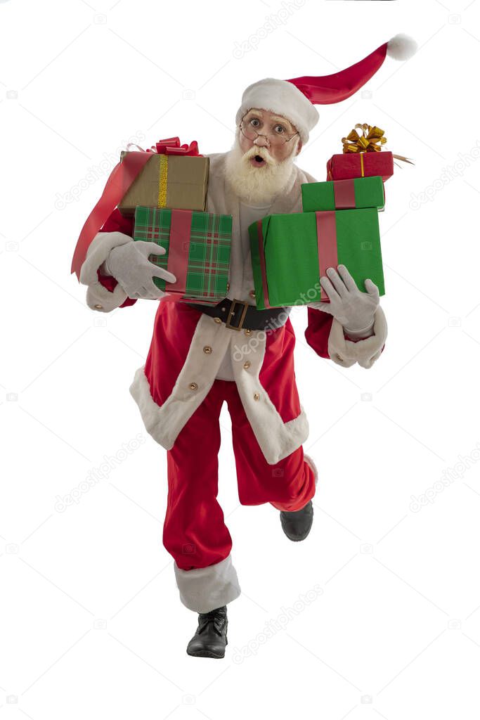 Santa Claus on white background isolated. Senior male actor old man with a real white beard in the role of Father Christmas bringing wrapped boxes xmas gifts. Hurrying, late, dancing, jumping, running.