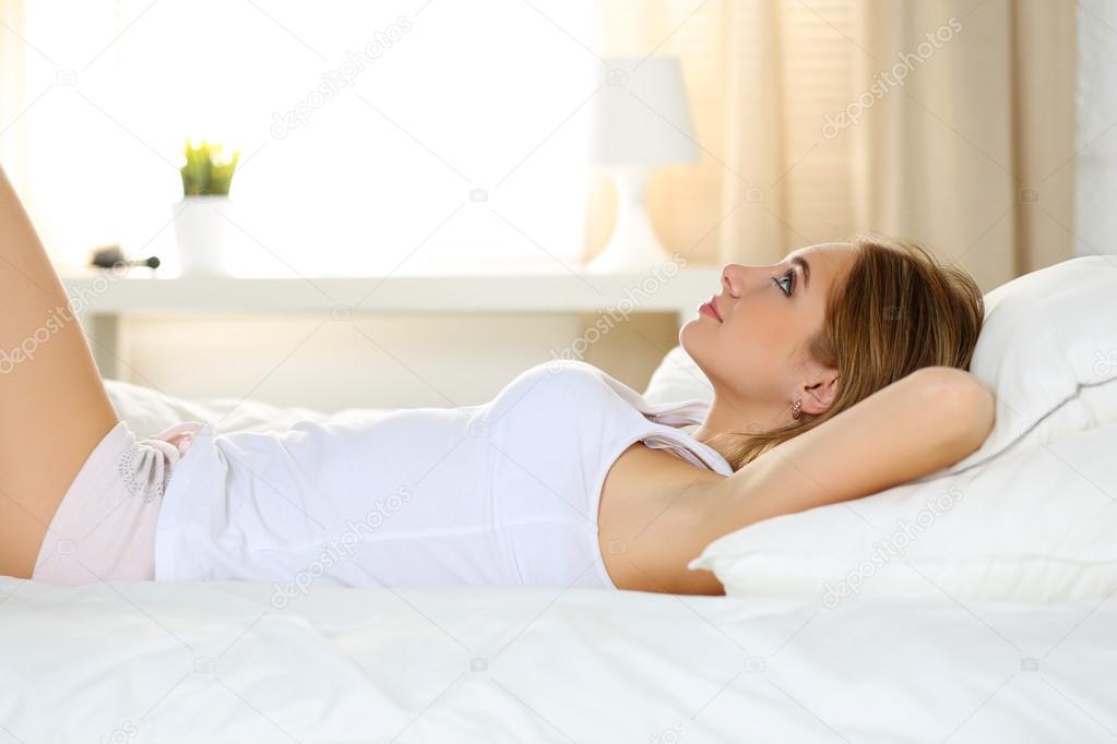 Young beautiful blonde smiling woman portrait wake up early morn