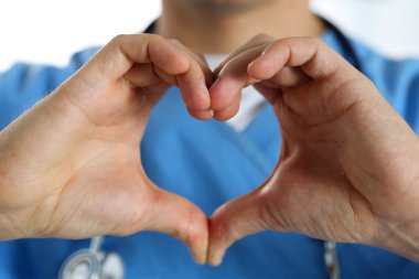 Hands of male medicine therapeutist doctor wearing blue uniform