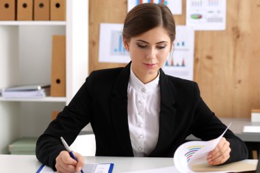 Beautiful businesswoman sit at workplace in office