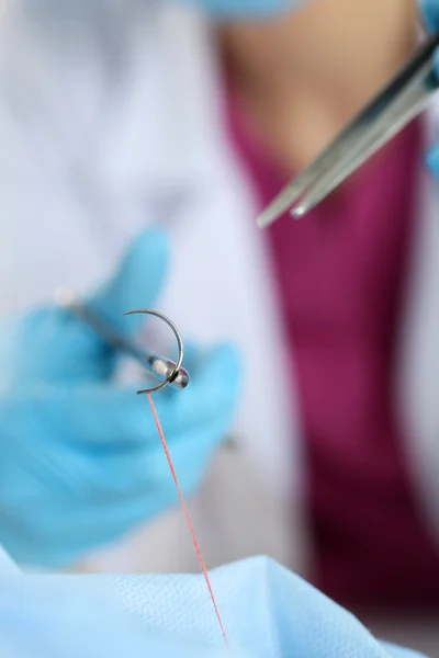 Surgeon hand hold needle, forceps and tweezers — Stock Photo, Image