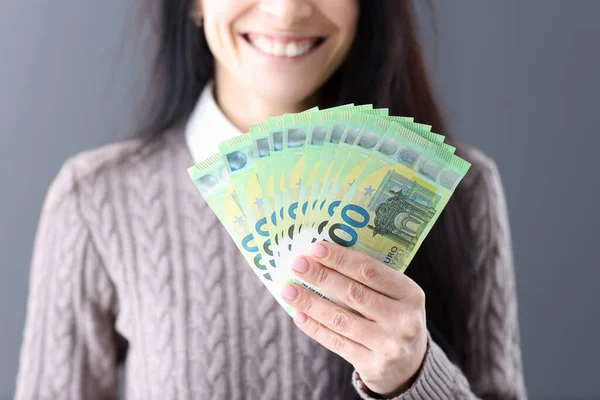 Woman holding euro cash in her hands closeup