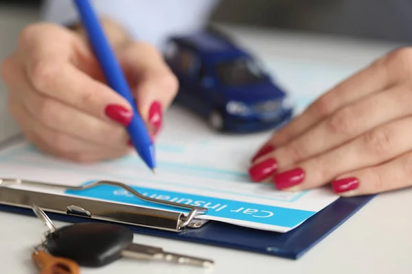 Makler füllt Kfz-Versicherungsunterlagen mit Stift aus — Stockfoto