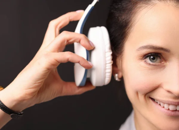Portrait of young brunette woman with headphones on her head — Stock Photo, Image